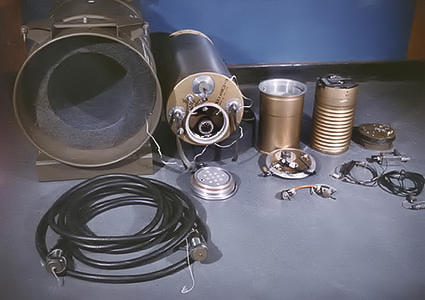 A view of the interior components of the W45 MADM, showing (from left) the packing container, warhead, code-decoder, and firing unit. The MADM was a similar design to the SADM